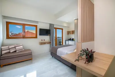 a bedroom with a bed and a couch in it at Chrysa Apartments in Chania Town