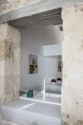a kitchen with a sink in a stone wall at Elorhouse in the charming neighborhood of KoumKapi in Chania Town