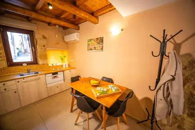 a kitchen with a table and chairs and a sink at Athena's House in Chania Town