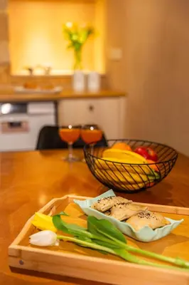 a cutting board with a basket of fruit and vegetables on a table at Athena's House in Chania Town