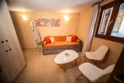 a living room with a couch and a table at Athena's House in Chania Town