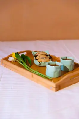 a tray with a plate of food on a bed at Athena's House in Chania Town