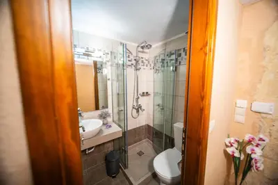a bathroom with a shower and a toilet and a sink at Athena's House in Chania Town