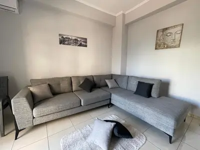 a living room with a couch and a table at Jomaa luxury residence in Chania Town