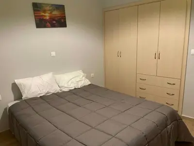 a bedroom with a large bed and a cabinet at Jomaa luxury residence in Chania Town