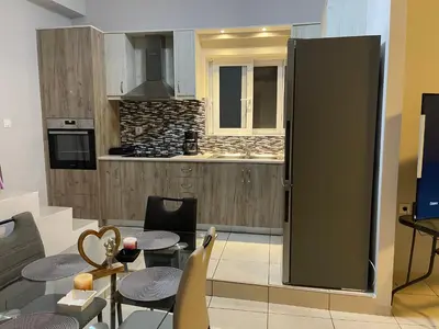 a kitchen with a large refrigerator in a room at Jomaa luxury residence in Chania Town