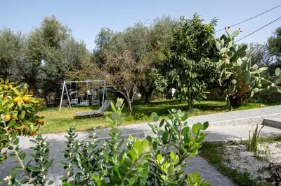 a park with a playground and a swing at Green Hill Villa in Daratso