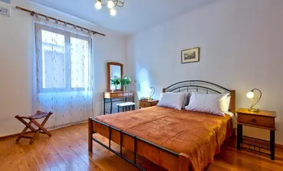 a bedroom with a large bed and a window at Aphrodite House in Chania Town