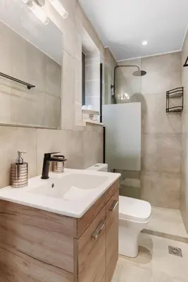 a bathroom with a white sink and a toilet at Brand new Villa Volakas BY APOKORONAS VILLAS in Gavalochori