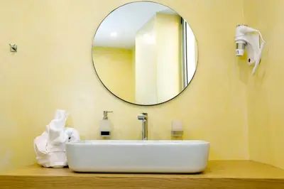 a bathroom with a white sink and a mirror at Exquisite Crete Villa Villa Kleanthi 4 Bedroom Private Pool in Stalos