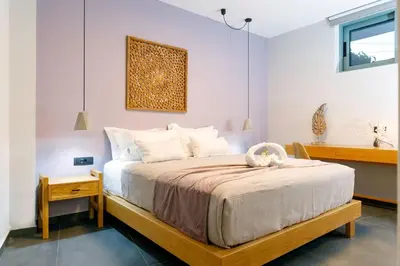 a bedroom with a large bed with a wooden frame at Exquisite Crete Villa Villa Kleanthi 4 Bedroom Private Pool in Stalos