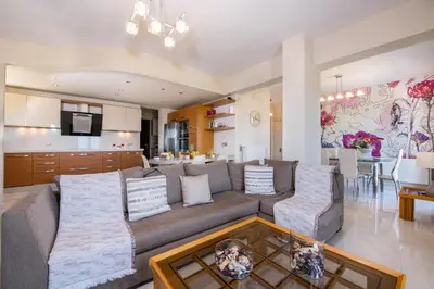 a living room with a couch and a dining room at Iliada by Vintage Travel in Maleme