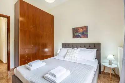a bedroom with a bed with two towels on it at K_Kostas Apartment in Daratso