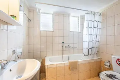 a bathroom with a tub and a sink at K_Kostas Apartment in Daratso