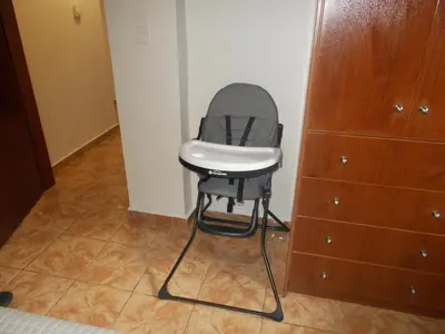 a chair sitting in the corner of a room at K_Kostas Apartment in Daratso