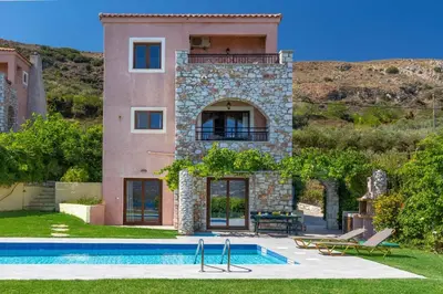 a house with a swimming pool in front of it at Villa Forteza in Kalami