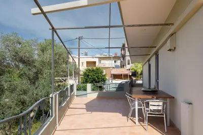 a balcony of a house with a table and chairs at Suncatcher House by 8essentially in Chania Town