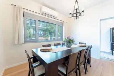 a dining room with a table and chairs at Suncatcher House by 8essentially in Chania Town