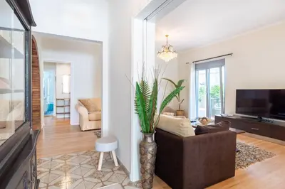 a living room with a couch and a tv at Suncatcher House by 8essentially in Chania Town