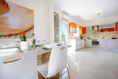 a kitchen with a table and some chairs in it at Geas House Ammos in Kolymvari