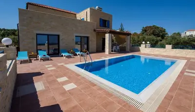 an external view of a villa with a swimming pool at Villa Aliki - Traditional stone house with maximum privacy and stunning views ! in Xamoudhokhórion