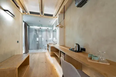 a kitchen with a counter and chairs in a room at Poem Suites in Chania Town