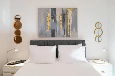 a bedroom with a white bed with white pillows at Aeri Home - At Nea Chora beach w. Parking included in Chania Town