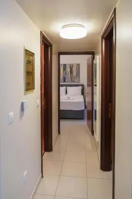 a hallway leading to a bedroom with a bed at Aeri Home - At Nea Chora beach w. Parking included in Chania Town