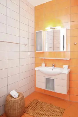 a bathroom with a sink and a mirror and a stool at Aeri Home - At Nea Chora beach w. Parking included in Chania Town