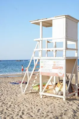 a lifeguard tower on a beach with people in the water at Aeri Home - At Nea Chora beach w. Parking included in Chania Town