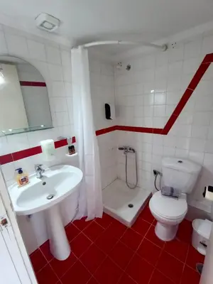 a bathroom with a white sink and a toilet at Kumba in Nea Chora in Chania Town