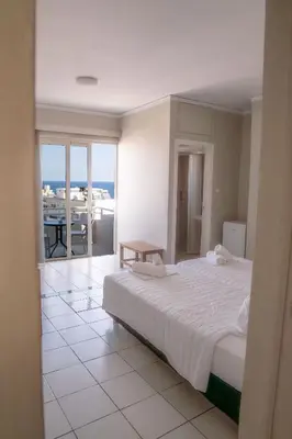 a bedroom with a bed and a view of the ocean at Kumba in Nea Chora in Chania Town
