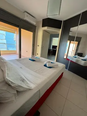 a large bed in a room with a mirror at Seaty Luxury apartment in Chania Town