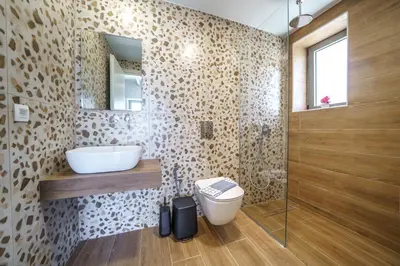 a bathroom with a toilet and a sink and a mirror at NAFSIKA XENIA-VILLA ARGO in Plátanos