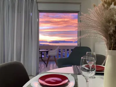 a dining room with a table with a view of the ocean at Stephanie's Place - Charming Apartment with Sea View in Chania Town