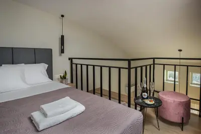 a bedroom with a bed and a table with a stool at Cove Elafonisi Apartments in Elafonisi