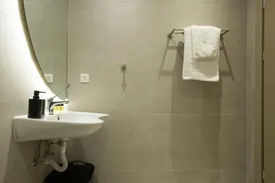 a bathroom with a sink and a mirror at Cove Elafonisi Apartments in Elafonisi