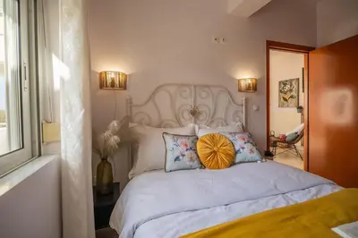 a bedroom with a white bed with a yellow pillow on it at Ammoutsiani 2 Cozy Apartment by 8essentially in Chania Town