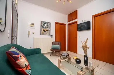 a living room with a green couch and a glass table at Ammoutsiani 2 Cozy Apartment by 8essentially in Chania Town