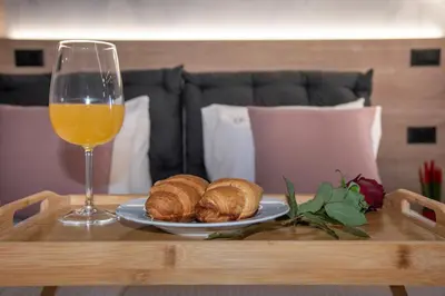 a table with a glass of orange juice and croissants at ALPHA SUITES in Chania Town