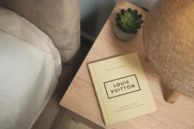 a book on a table next to a bed at ModernPastel Studio-Near Old Port in Chania Town