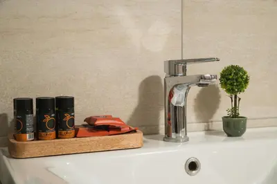 a bathroom sink with a faucet and a toothbrush at ModernPastel Studio-Near Old Port in Chania Town