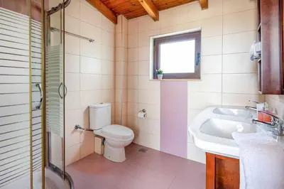 a bathroom with a toilet and a sink at Villa Portokalia Platanias in Plataniás