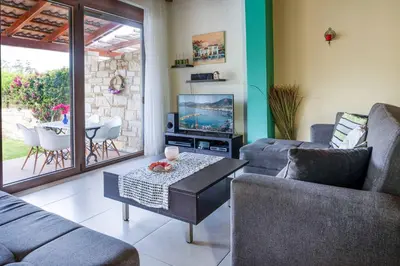 a living room with couches and a tv and a table at Villa Portokalia Platanias in Plataniás