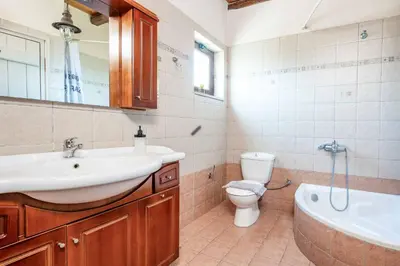 a bathroom with a sink and a toilet and a tub at Villa Koule in Kalami