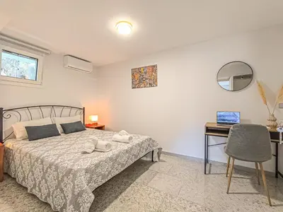 a bedroom with a bed and a desk at Comfy flat with large terrace, Fiber internet and private parking in Chania Town