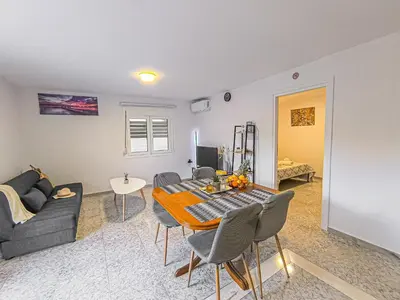 a living room with a table and a couch at Comfy flat with large terrace, Fiber internet and private parking in Chania Town