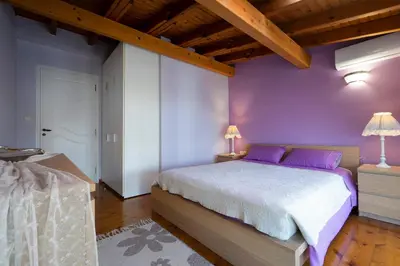 a bedroom with purple walls and a large bed at Purple Apartment Chania in Chania Town