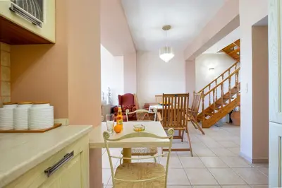 a kitchen and dining room with a table and chairs at Purple Apartment Chania in Chania Town