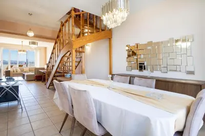 a dining room with a white table and chairs at Purple Apartment Chania in Chania Town